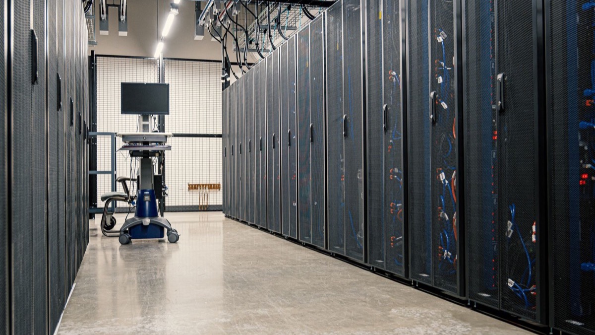 Enterprise data-center server room, illustrating internal AI running behind the firewall with data staying inside company infrastructure